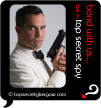 Top Secret Quote Bubble in black, with male spy in white tuxedo holding gun