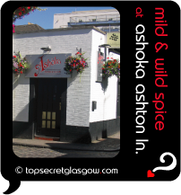 Top Secret Quote Bubble in black, with photo of Ashoka Ashton Lane exterior; white-painted mews-style building with black trims; bright red flowers in hanging baskets all around.  Caption: 'mild and wild spice'