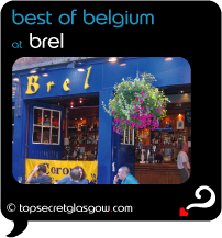 Top Secret Quote Bubble in black, with photo of exterior of Brel; bright blue painted walls with acid yellow signage, bright hanging floral baskets.  Pavement tables and chairs. Caption: 'best of belgium'