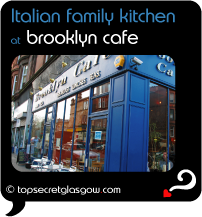 Top Secret Quote Bubble in black, with photo of exterior of Brooklyn Cafe; bright blue painted walls with brass signage, reflections of surrounding red sandstone buildings in windows. Caption: 'Italian family kitchen'