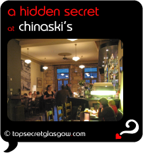 Top Secret Quote Bubble in black, with photo of interior in evening, towards the bar. Caption: 'a hidden secret'
