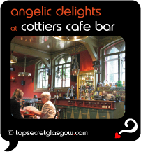 Top Secret Quote Bubble in black, with interior image of Cottier's bar, with 2 women at a table.  Caption in orange: 'angelic delights'