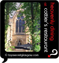 Top Secret Quote Bubble in black, with photo of church hall and huge black BBQ umbrella-shades in beer garden, through trees. Caption: 'heavenly dining' 