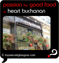 Top Secret Quote Bubble in black, with photo of window and hanging pots of flowers. Caption: 'passion for good food'