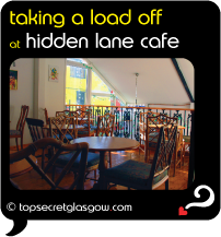 Top Secret Glasgow Quote Bubble showing charming cafe interior.
Caption: taking a load off