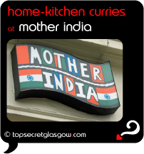 Top Secret Quote Bubble in black, with photo of close up of logo on side of building. Caption: 'home-kitchen curries'