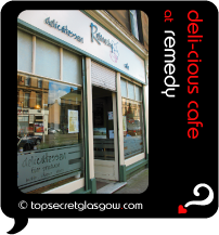 Top Secret Quote Bubble in black, with photo of the shop front, reflecting Mulberry Street.  Caption: 'deli-cious cafe'