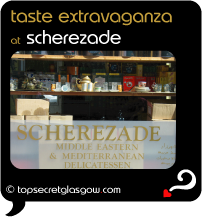 Top Secret Quote Bubble in black, with exterior shot of shop front, shelves in window. Caption: 'taste extravaganza'