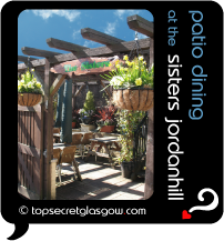 Top Secret Quote Bubble in black, with photo of the cute outdoors garden-patio dining area. Caption: 'patio dining'