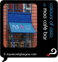 Top Secret Quote Bubble in black, with photo of Cafe Mao exterior, with prominent blue awning bearing logo.  Caption: 'colours of asia'