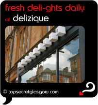Top Secret Quote Bubble in black, with photo of logo above windows. Caption: 'fresh deli-ghts daily'