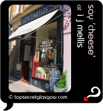 Top Secret Quote Bubble in black, with photo of shop front in the sun. Caption: 'say cheese'