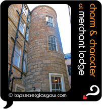 Top Secret Glasgow lozenge showing exterior stone curved tower. Caption: charm & character