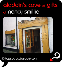 Top Secret Quote Bubble in black, with photo of main door and side window. Caption: 'aladdin's cave of gifts'